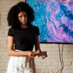 A woman standing in front of a flat screen TV