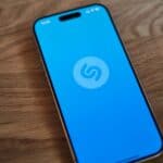 A blue phone sitting on top of a wooden table