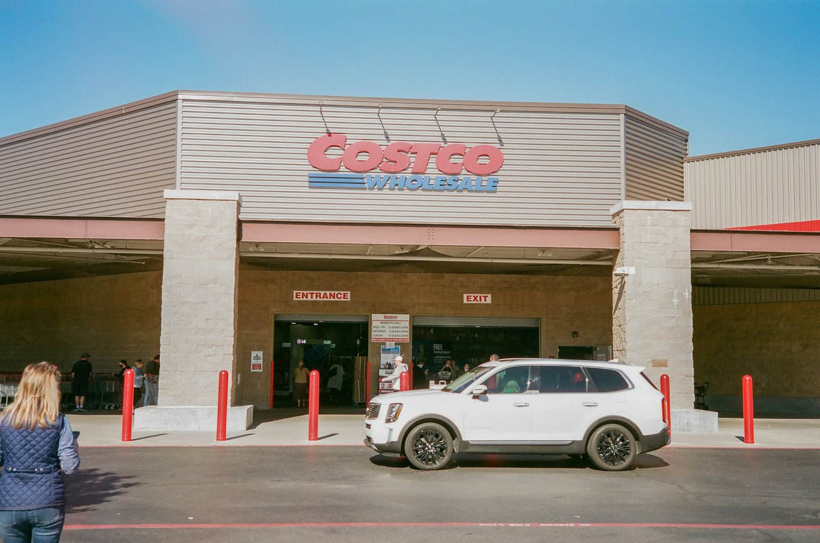 a white car parked in front of a costco store