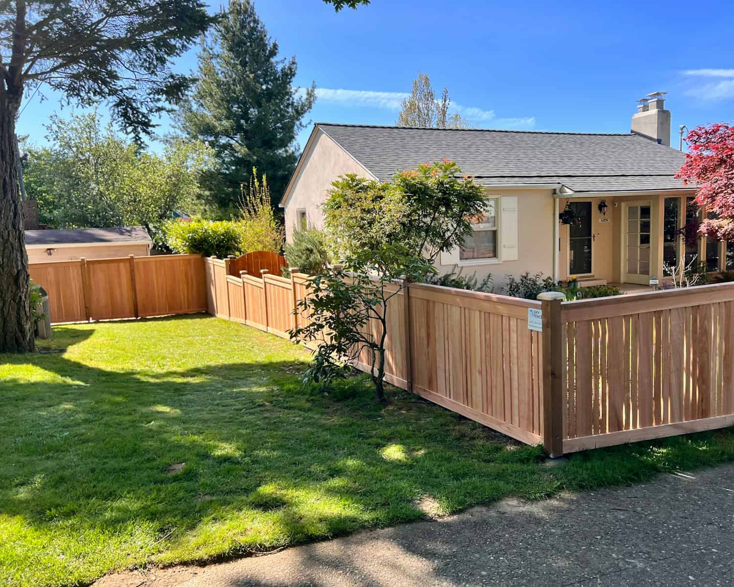 a house with a wooden fence in front of it