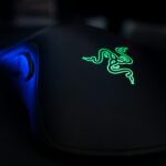 a close up of a computer mouse with a lizard on it