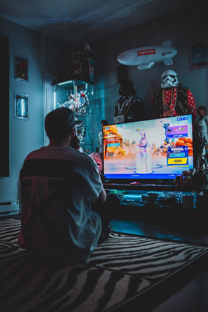 man in red shirt watching tv