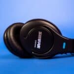 black sony headphones on blue surface